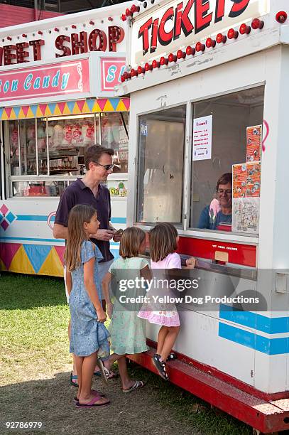 family at ticket booth at fair - amusement park ticket stock pictures, royalty-free photos & images