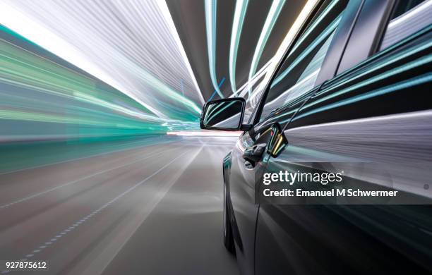 black german car drives through a modern tunnel - blur sports technology stockfoto's en -beelden