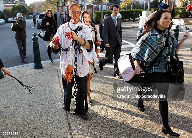 Anti-abortion demonstrators Albert Stecklein of Bethesda, Maryland, and Diana Roccograndi of Wilkes-Barre, Pennsylvania, and wear paper masks of...