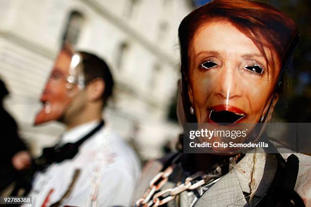 Anti-abortion demonstrator Diana Roccograndi of Wilkes-Barre, Pennsylvania, wear a paper mask of Speaker of the House Nancy Pelosi while protesting...
