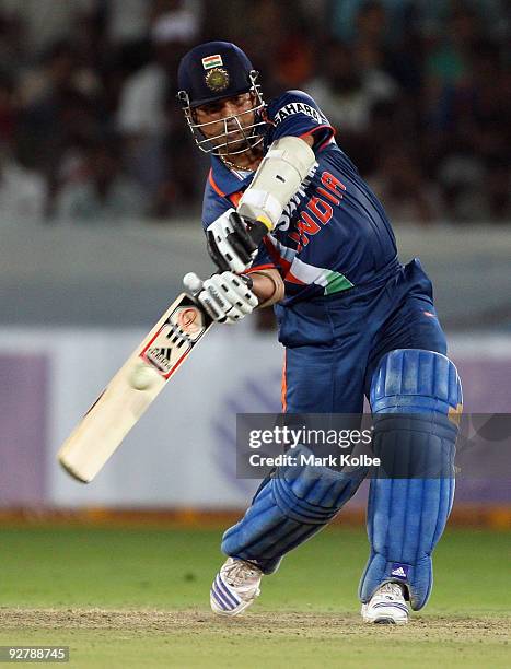 Sachin Tendulkar of India hits out during the fifth One Day International match between India and Australia at Rajiv Gandhi International Cricket...