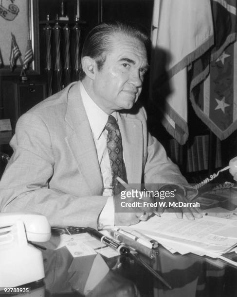 American politician Governor of Alabama George C. Wallace signs a document at his desk, Montgomery, Alabama, 1970s.