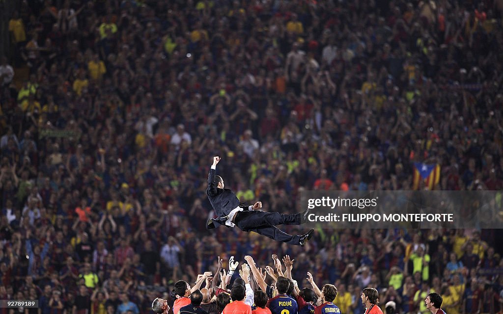 Barcelona coach Pep Guardiola is thrown