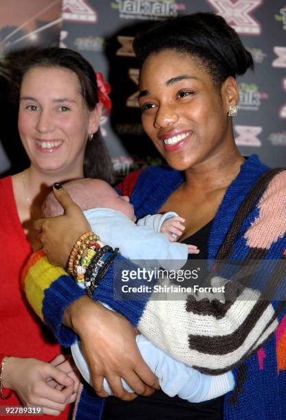 Rachel Adedeji greets baby Liam Bryan at TalkTalk store after being voted out of The X Factor on November 5, 2009 in Warrington, England.