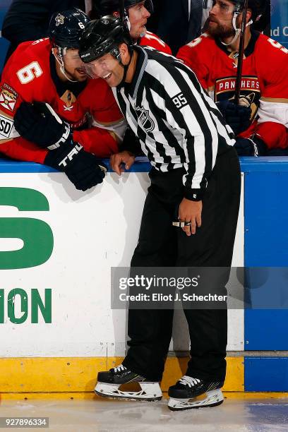 Linesmen Jonny Murray shares a laugh with Alex Petrovic of the Florida Panthers during a break in the action against the Philadelphia Flyers at the...