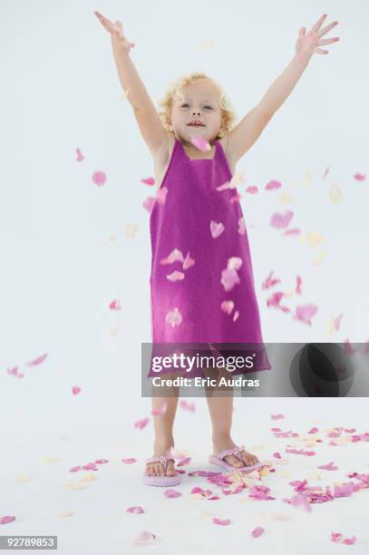 girl tossing flower petals and smiling - falling petals stock pictures, royalty-free photos & images