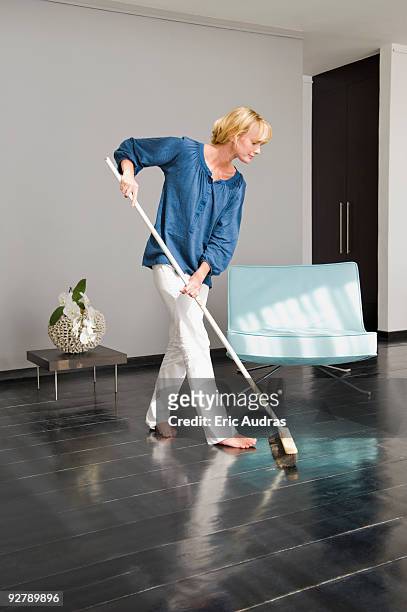 woman cleaning floor with a mop - woman sweeping stock pictures, royalty-free photos & images