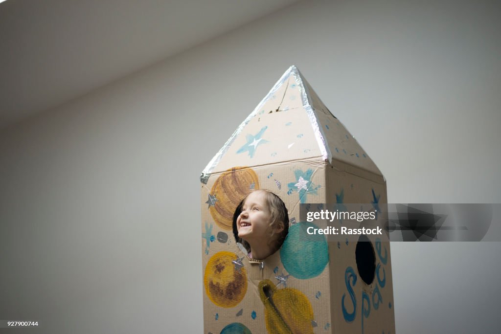 Little astronaut ready to travel to the stars. Playing with spaceship