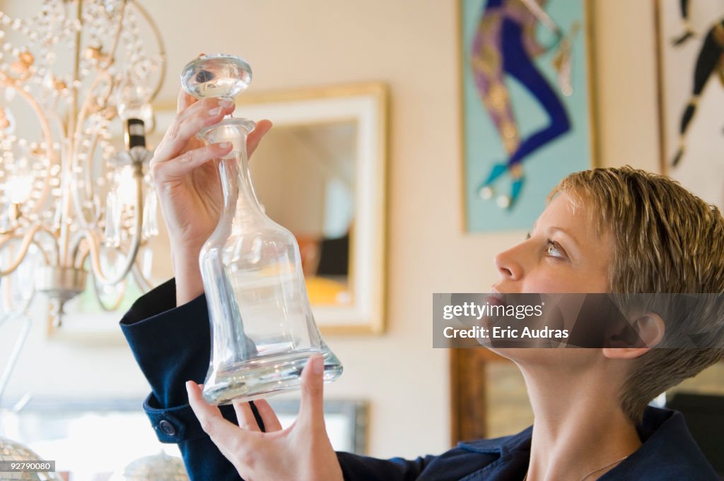 Woman holding a decanter in a store