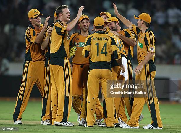 Doug Bollinger of Australia celebrates with his team mates after the wicket Ashish Nehra of India during the fifth One Day International match...