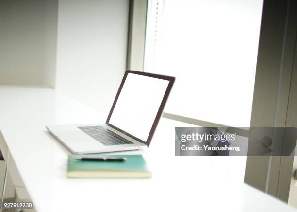 notebook on the desk,empty screen,close the window - bokeh computer screen stock pictures, royalty-free photos & images