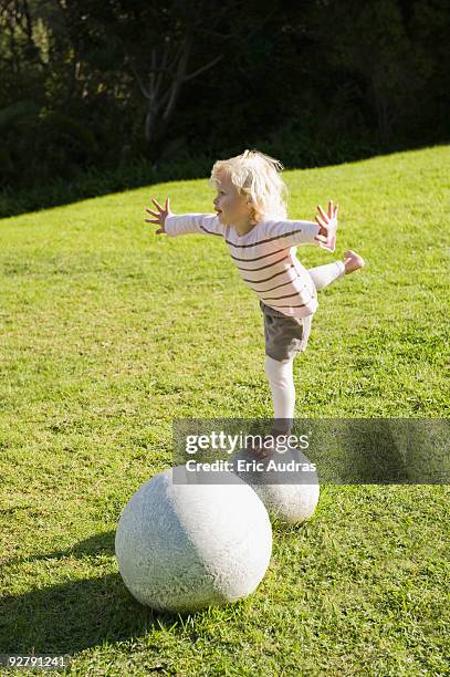 girl balancing herself on a round stone - standing on one leg stock pictures, royalty-free photos & images