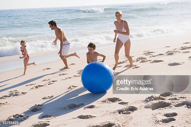 family enjoying vacations on the beach - flirt barefoot blonde stock-fotos und bilder