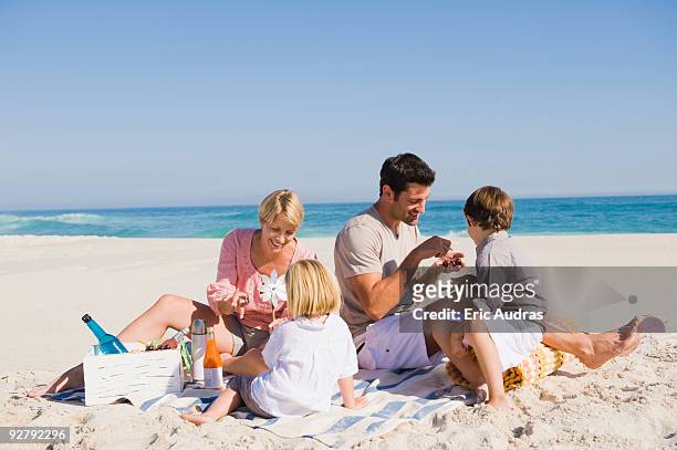 family on vacations on the beach - flirt barefoot blonde stock-fotos und bilder