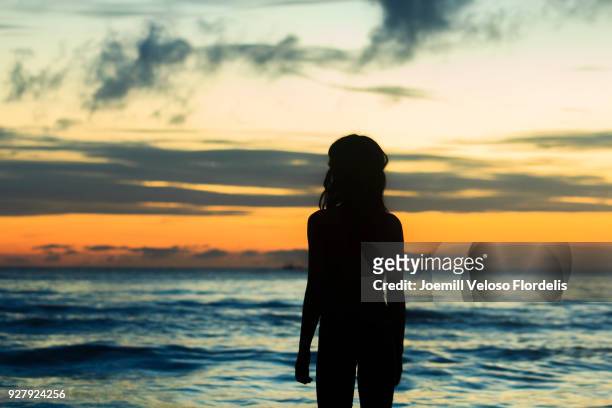 a girl watching the sunset by the beach (boracay island, malay, aklan, philippines) - joemill flordelis stock pictures, royalty-free photos & images