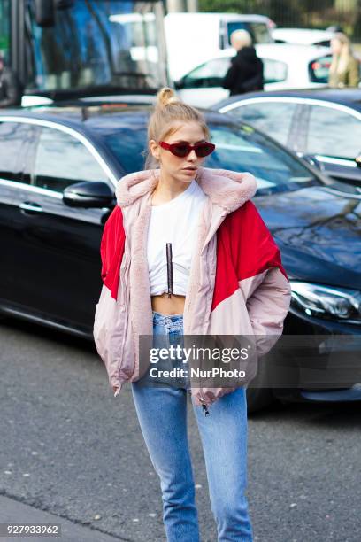 Lena Perminova wears a red and pink bomber jacket, cropped jeans, white shoes, sunglasses, outside Giambattista Valli, during Paris Fashion Week...