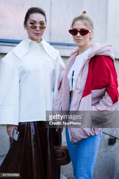 Lena Perminova wears a red and pink bomber jacket, cropped jeans, white shoes, sunglasses, outside Giambattista Valli, during Paris Fashion Week...