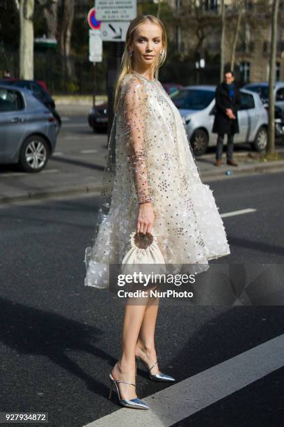 Tatiana Korsakova wears a white lace dress, outside Giambattista Valli, during Paris Fashion Week Womenswear Fall/Winter 2018/2019, on March 5, 2018...