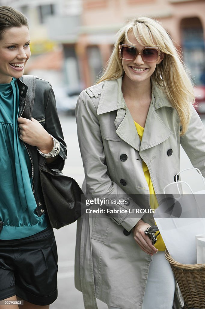 Two women walking with shopping bags