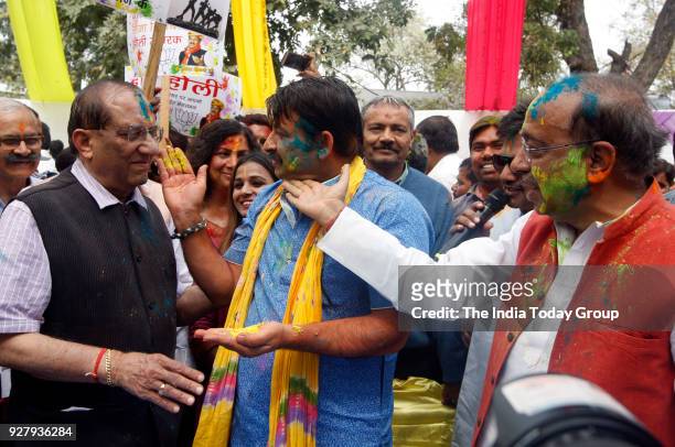 Manoj Tiwari celebrates Holi with Vijay Goel and other party members at Holi Milan Event at BJP office in New Delhi.