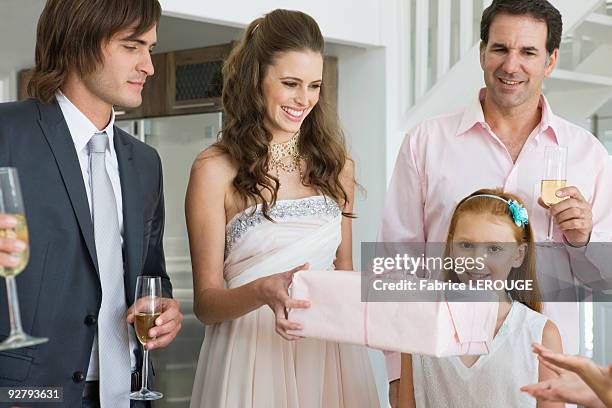 bride receiving a gift from a guest in a party - wedding guest gifts stock pictures, royalty-free photos & images