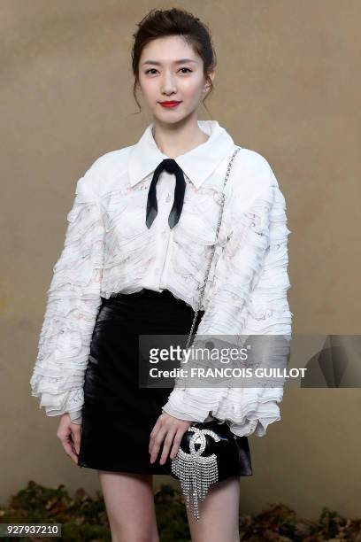 Chinese actress Maggie Jiang poses for a photo-call before the Chanel's 2018/2019 fall/winter collection fashion show on March 6, 2018 in Paris. /...