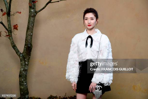 Chinese actress Maggie Jiang poses for a photo-call before the Chanel's 2018/2019 fall/winter collection fashion show on March 6, 2018 in Paris. /...