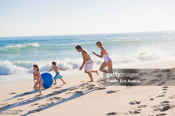 family enjoying vacations on the beach - flirt barefoot blonde stock-fotos und bilder