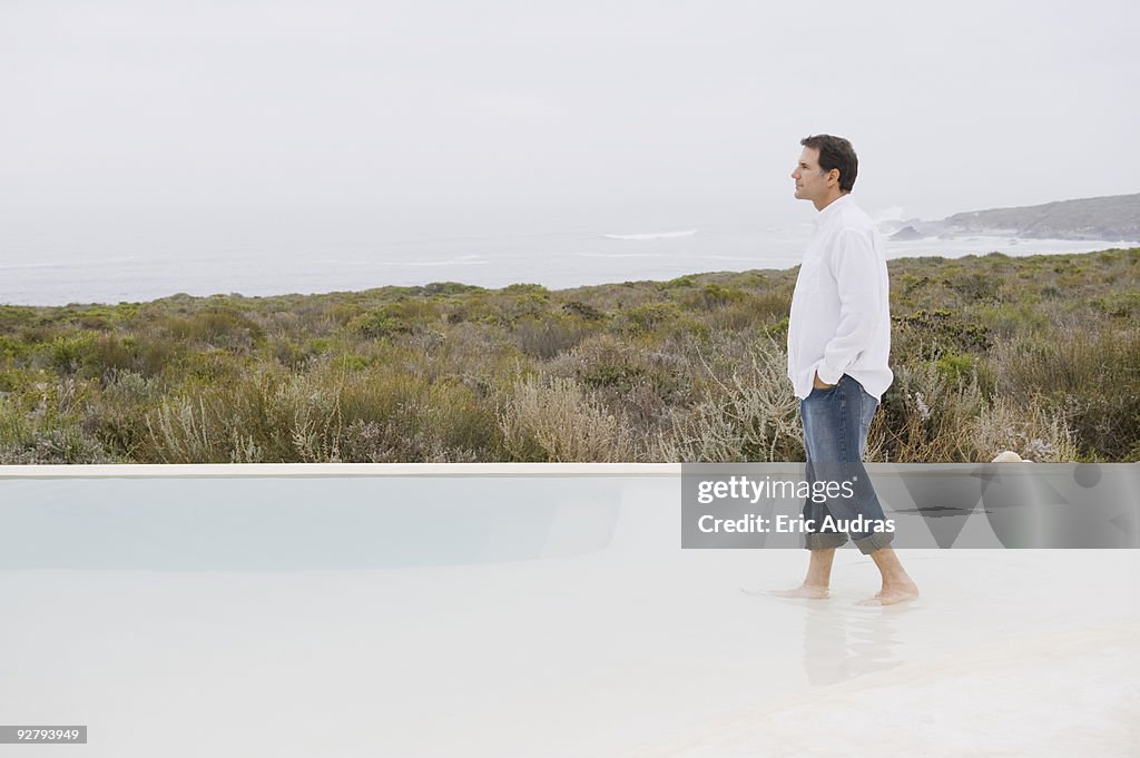 Man walking in an infinity pool