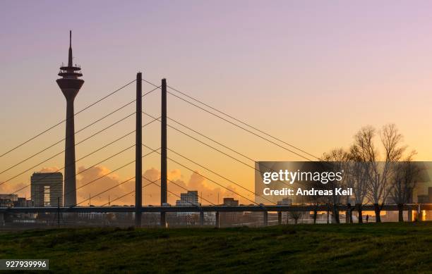 city gate, rhine tower and rheinknie bridge in the evening light, duesseldorf, north rhine-westphalia, germany - porta da cidade imagens e fotografias de stock