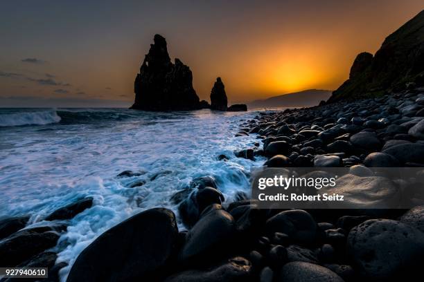 rock formation ribeira de janela at sunrise with black stones at the beach, porto moniz, madeira, portugal - janela stock pictures, royalty-free photos & images