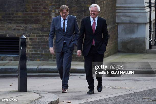 Britain's Secretary of State for Exiting the European Union David Davis reacts as he talks with the European Parliament's Brexit coordinator Guy...