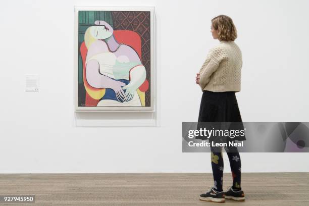 Woman poses in front of "The Dream" by Pablo Picasso at the Tate Modern on March 6, 2018 in London, England. "Picasso 1932: Love, Fame and Tragedy"...