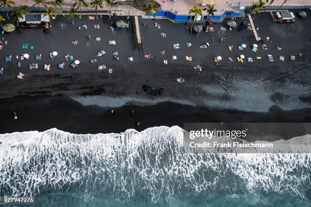 surf, bathing people on black lava beach, puerto naos, la palma, canary islands, spain - puerto naos stock pictures, royalty-free photos & images