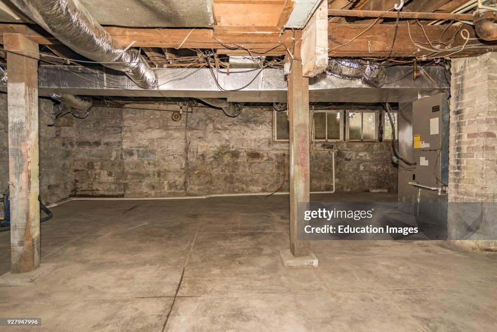 Middle Class Basements Unfinished basement interior of middle-class American home in... News ...