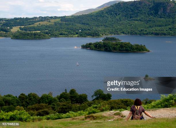 Woman looking at the view of Derwentwater, The Lake District, Cumbria, UK.