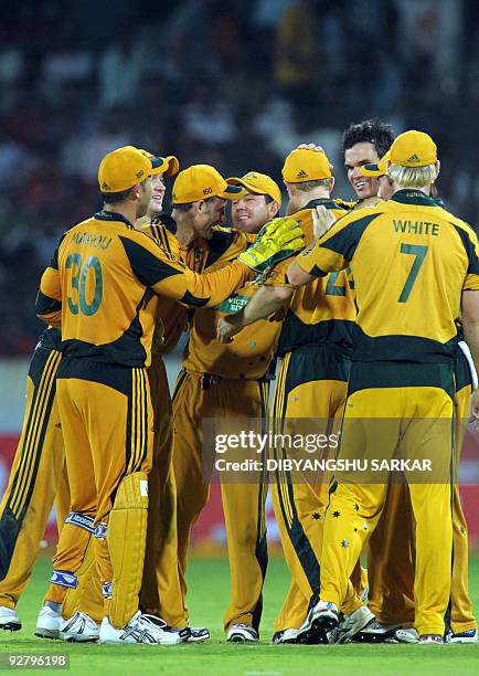 Australian cricket captain Ricky Ponting celebrates with teammates the wicket of Indian cricketer Harbhajan Singh , during the fifth One-Day...