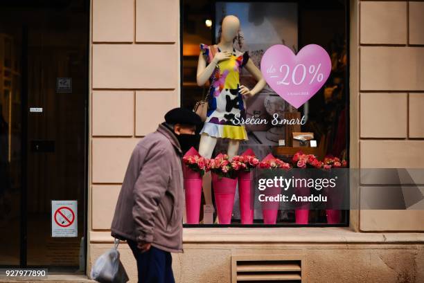 Man walks past the store at the Knez Mihailova Street in Belgrade, Serbia on March 04, 2018. The city has a different historical heritage and unique...