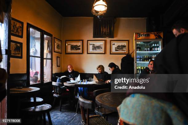 People are seen in a restaurant at the Knez Mihailova Street in Belgrade, Serbia on March 04, 2018. The city has a different historical heritage and...