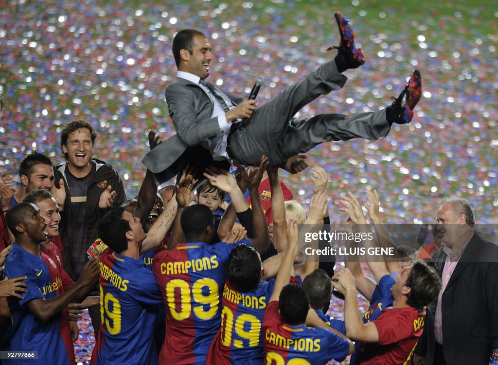 Barcelona players lift their coach Pep G