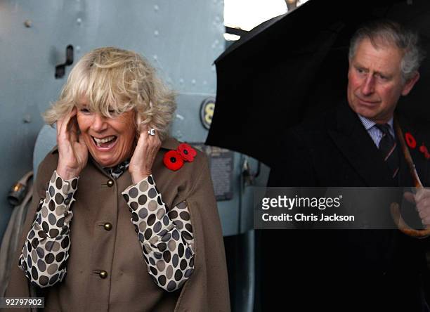 Camilla, Duchess of Cornwall puts her fingers in her ears as Prince Charles, Prince of Wales fires the gun on HMCS Haida on November 5, 2009 in...