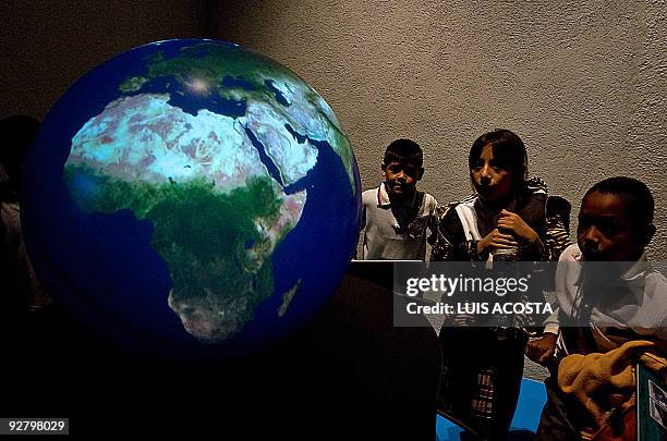 Students observe a globe during their visit to Papalote Children's museum in Mexico city, on November 4, 2009. Children in one of the world's most...