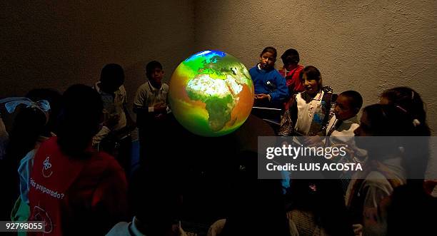 Students observe a globe during their visit to Papalote Children's museum in Mexico city, on November 4, 2009. Children in one of the world's most...