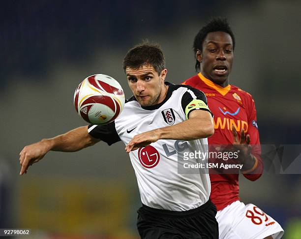 Stefano Okaka Chuka of AS Roma and Aaron Hughes of Fulham compete for the ball during the UEFA Europa League group E match between AS Roma and Fulham...