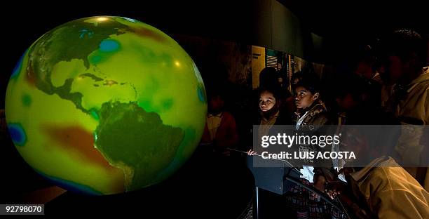 Students observe a globe during their visit to Papalote Children's museum in Mexico city, on November 4, 2009. Children in one of the world's most...