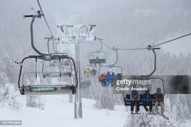 Tourists take a ski lift in the Kopaonik Ski Center the on March 6, 2018 near Belgrade, Serbia.