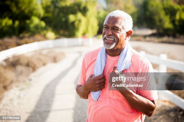 senior black man after workout - running outdoors stock pictures, royalty-free photos & images