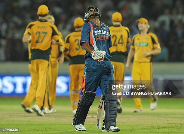 Australia cricketers celebrate as last Indian batsman Praveen Kumar reacts after loosing his wicket during the fifth One-Day International between...