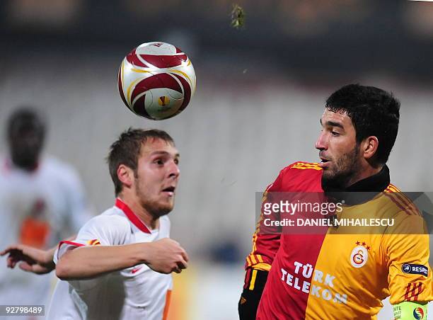 Arda Turan of Galatasaray vies for the ball with Cosmin Moti of Dinamo Bucharest during UEFA Europa League football match in Bucharest on November 5,...
