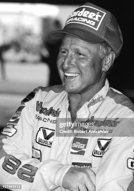 Racecar driver Cale Yarborough waits in the speedway garage prior to the start of the 1986 Daytona 500 stock car race at Daytona International...